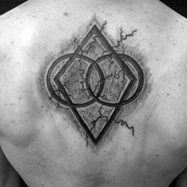 Geometric tattoo with Skyrim motifs: overlapping circles and diamond shape on back