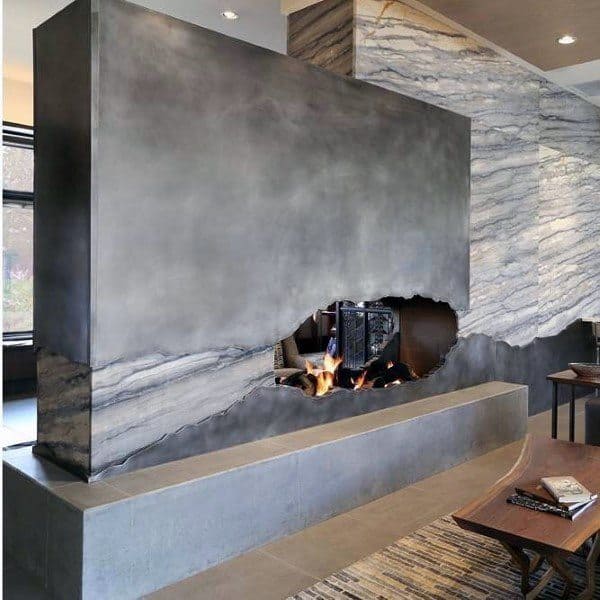 Concrete fireplace with a unique cut-out design, blending rugged textures and sleek modernity for a striking focal point.