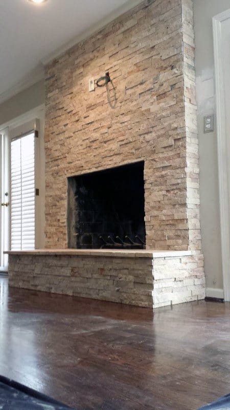 Modern stacked-stone fireplace with thin veneer tiles and a sleek minimalist design.