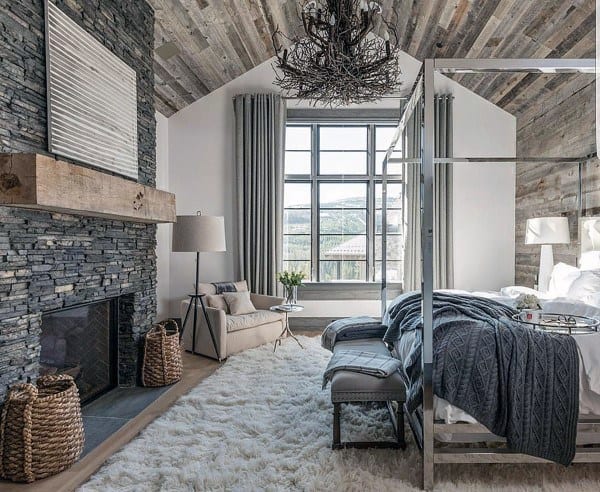 luxury rustic bedroom with stone fireplace