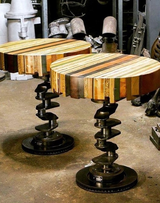 Upcycled stools with wooden block seats and automotive gear bases in an industrial setting.