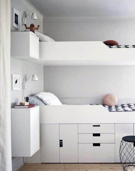 Sleek white bunk beds featuring built-in storage and wall-mounted lights in a modern bedroom