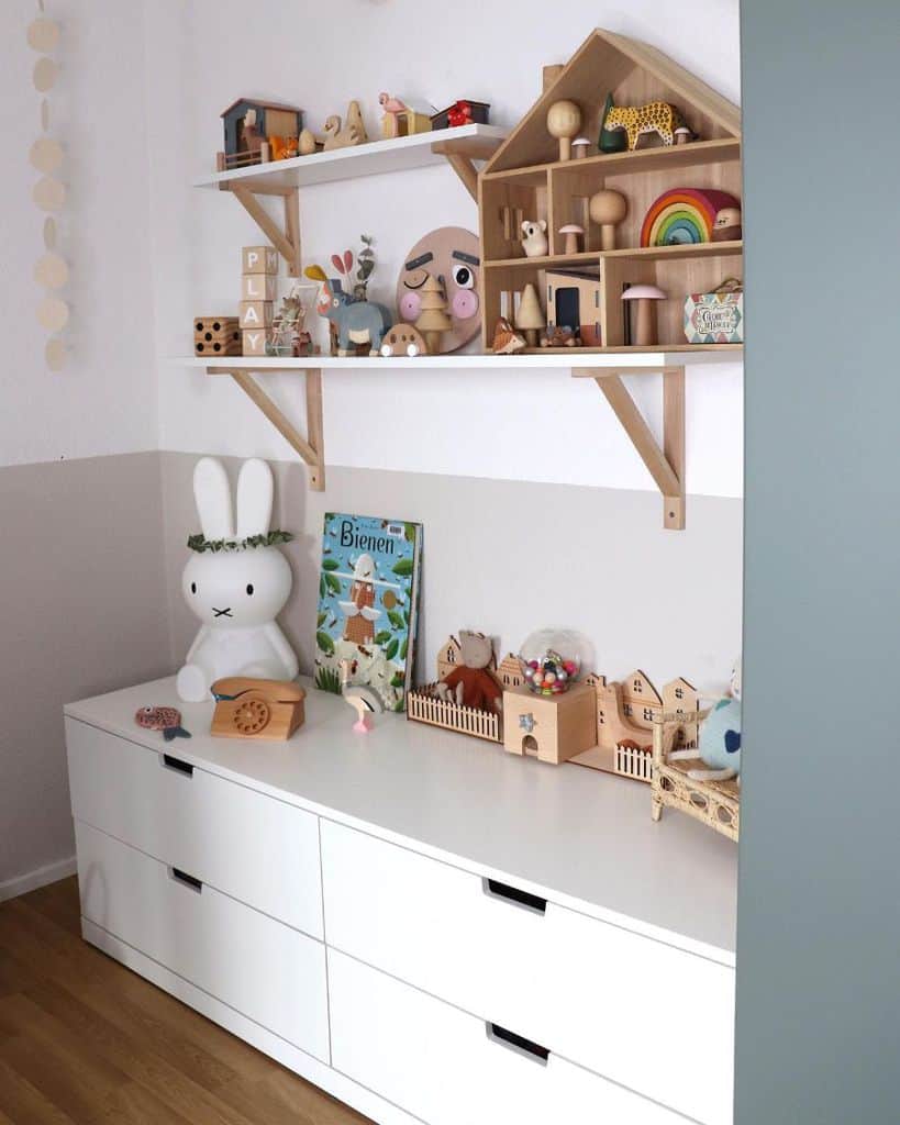 storage playroom ideas with white cabinets and wall shelf