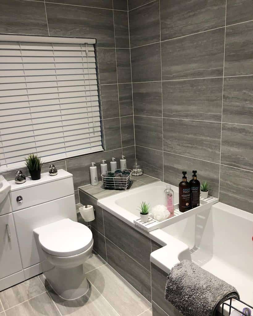 gray slate tile bathroom with large tub