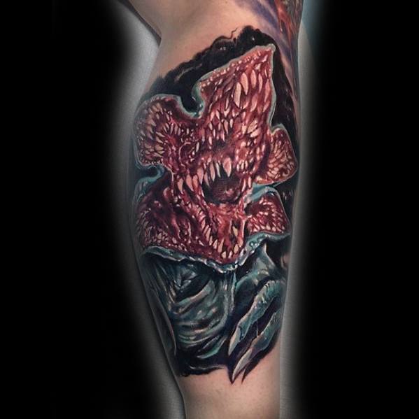 Realistic color tattoo of the Demogorgon from Stranger Things, showcasing its terrifying open mouth and sharp teeth with intense detail.