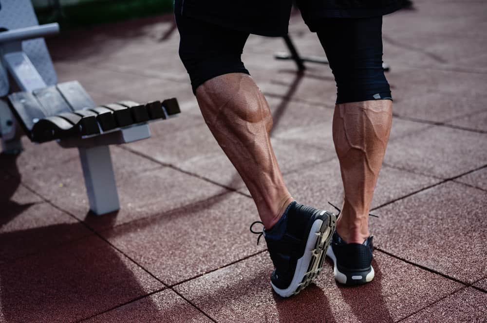 strong athlete legs of man in sneakers on outdoor training workout
