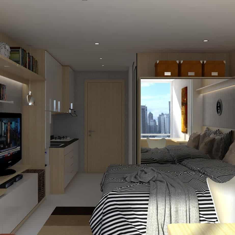 Compact studio apartment with striped bedding, built-in storage, and city view.