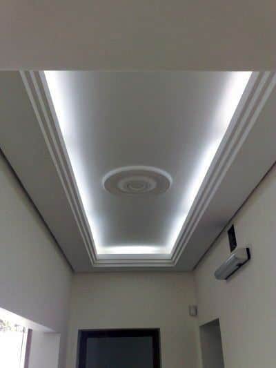 Modern interior with stunning crown molding lighting, featuring a unique circular design for an elegant look