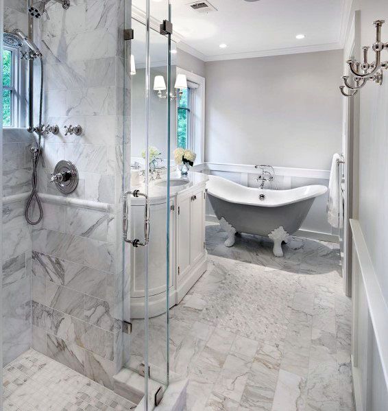 luxury bathroom with claw tub and marble walls