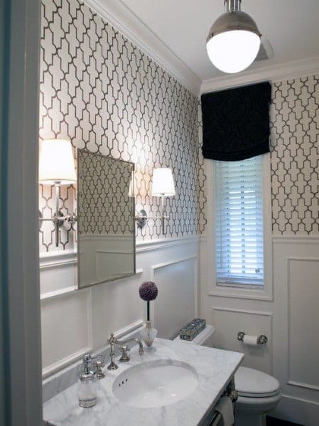 Elegant bathroom with patterned wallpaper, chair rail, marble sink, and a small window with blinds