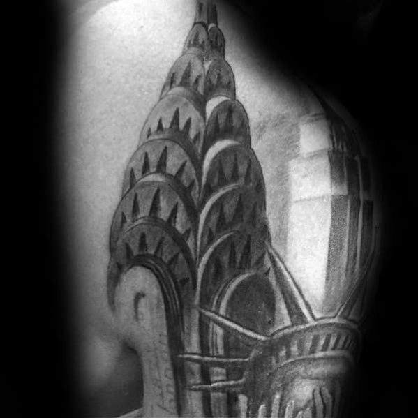 Realistic black-and-grey Chrysler Building tattoo with intricate shading, featuring the Statue of Liberty for a bold New York-inspired design.