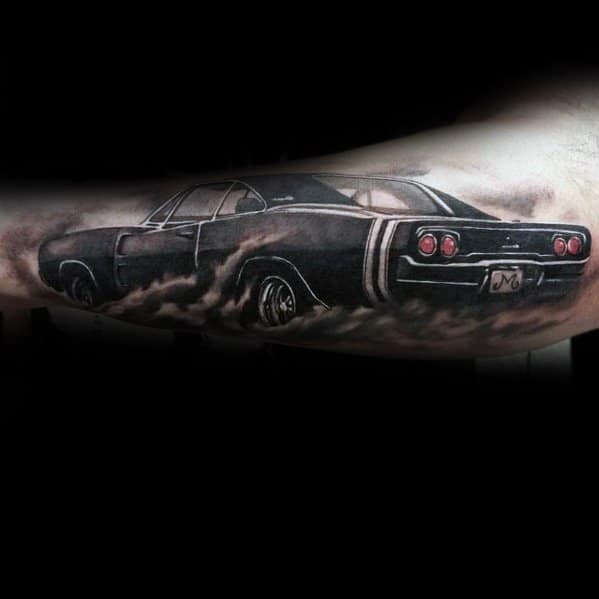 Realistic black and grey Dodge Charger tattoo with a smoky burnout effect, capturing the power and classic muscle car aesthetic.