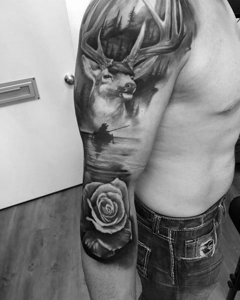 Realistic black and grey elk tattoo sleeve, featuring a detailed forest scene, a lake reflection, and a rose for a bold and nature-inspired design.