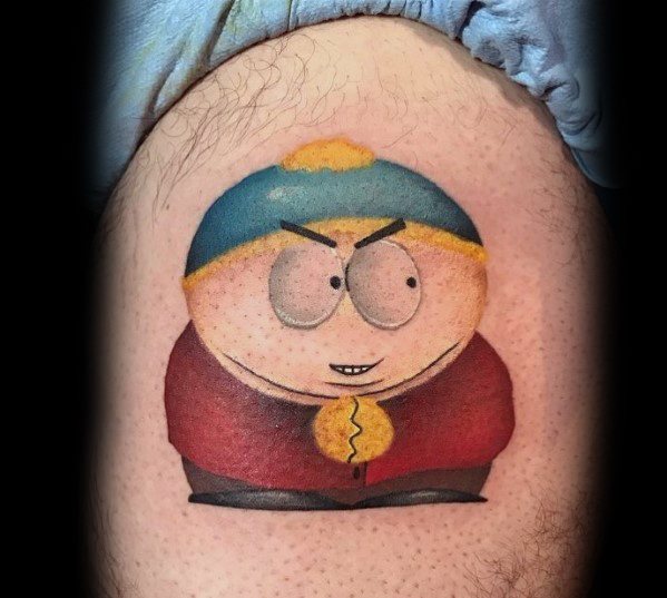 South Park tattoo of Cartman with a mischievous grin, featuring smooth shading, bold colors, and a classic cartoon-style design.