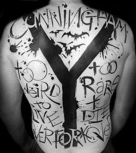 Bold black and white Hunter S. Thompson-inspired back tattoo featuring large abstract lettering, bats, and the quote "Too Weird to Live, Too Rare to Die."