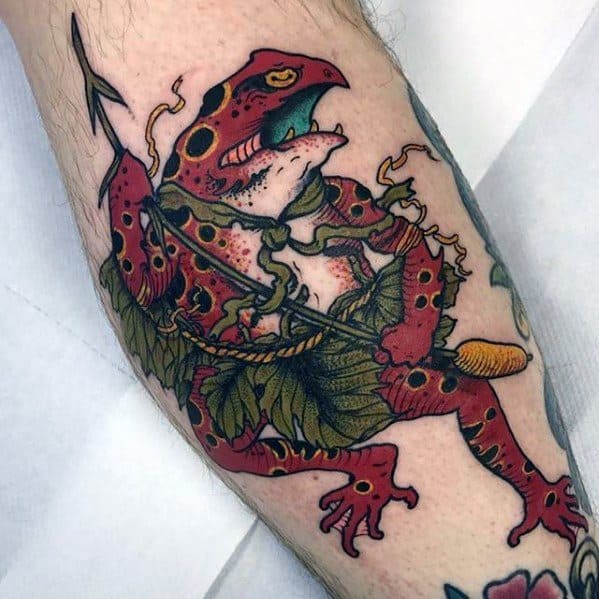 Japanese-style tattoo featuring a red warrior frog in dynamic motion, wearing leaf armor and gripping a staff, symbolizing strength and mythical folklore.