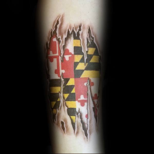 Maryland flag tattoo with a torn skin effect on the forearm, creating a bold 3D illusion of the flag beneath the surface.
