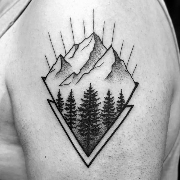 Geometric mountain tattoo on the upper arm, featuring bold outlines, pine trees, and dot shading for a modern and nature-inspired design.