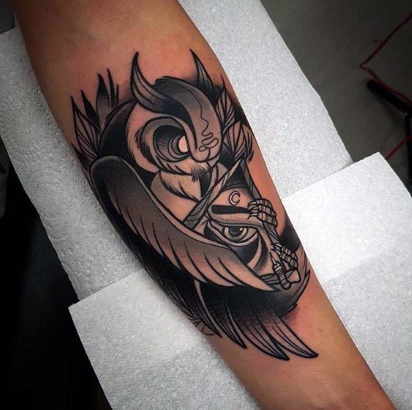 Neo-traditional black and grey owl tattoo with bold shading, sharp details, and a crescent moon, creating a striking and dynamic forearm design.