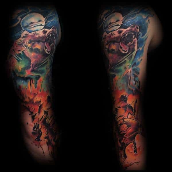 Vibrant full-sleeve tattoo featuring a roaring bear under a moonlit sky, with a dynamic rodeo scene below, blending bold colors and watercolor effects.