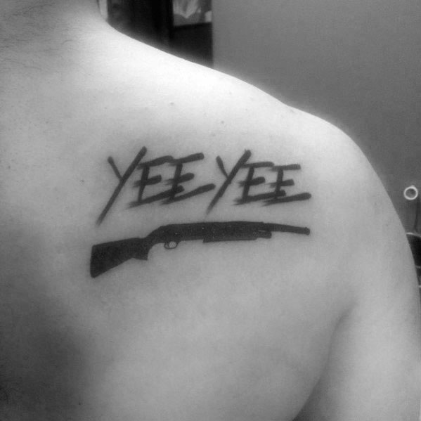 Minimalist "YEE YEE" tattoo on the upper back, featuring bold lettering above a simple black shotgun silhouette for a rugged design.
