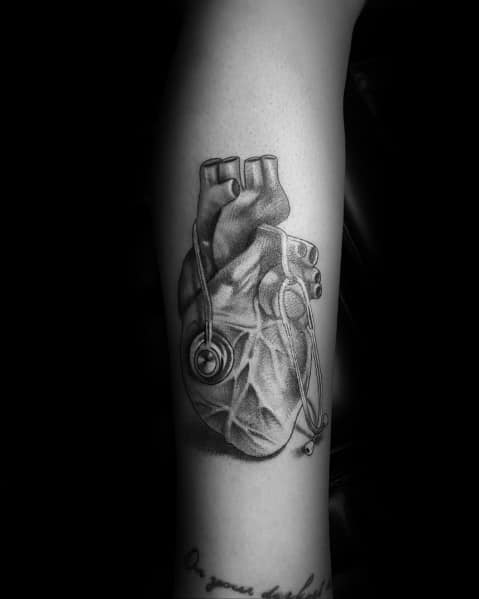 Realistic anatomical heart tattoo with a stethoscope, symbolizing a deep connection to medicine, cardiology, and the passion for saving lives.