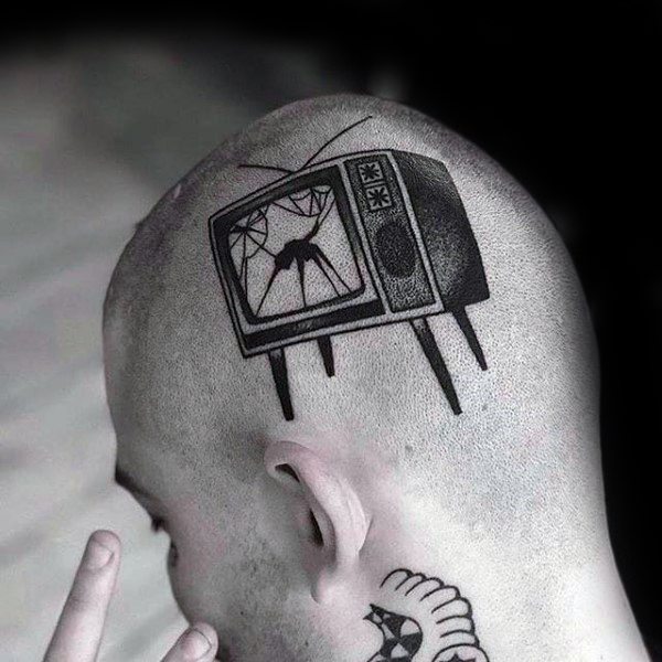 Black ink tattoo of a vintage TV with broken glass on the screen, showing a silhouetted figure, placed on the side of the head for a bold look.