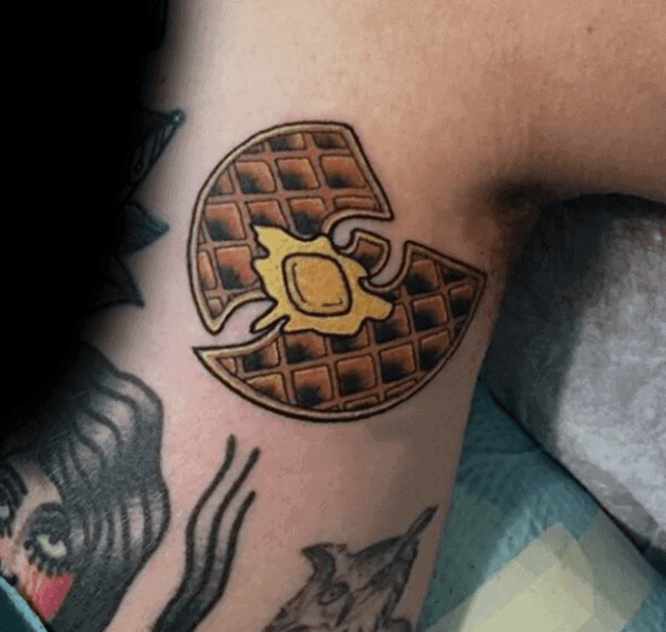 Wu-Tang Clan-inspired waffle tattoo with a pat of melting butter, blending hip-hop culture with a creative and unique breakfast theme.
