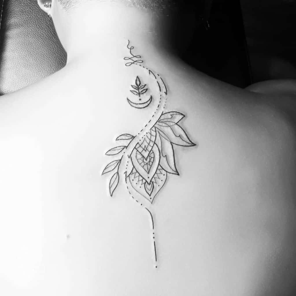 Unalome tattoo with floral and crescent moon details on the upper back, symbolizing spiritual growth, transformation, and enlightenment.