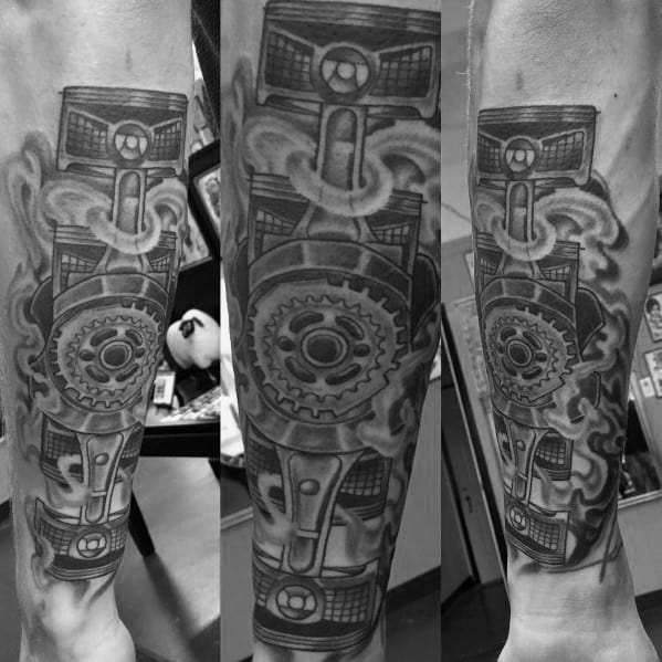 Black and grey Subaru-themed sleeve tattoo featuring detailed pistons, gears, and smoke effects, symbolizing the power of the boxer engine.
