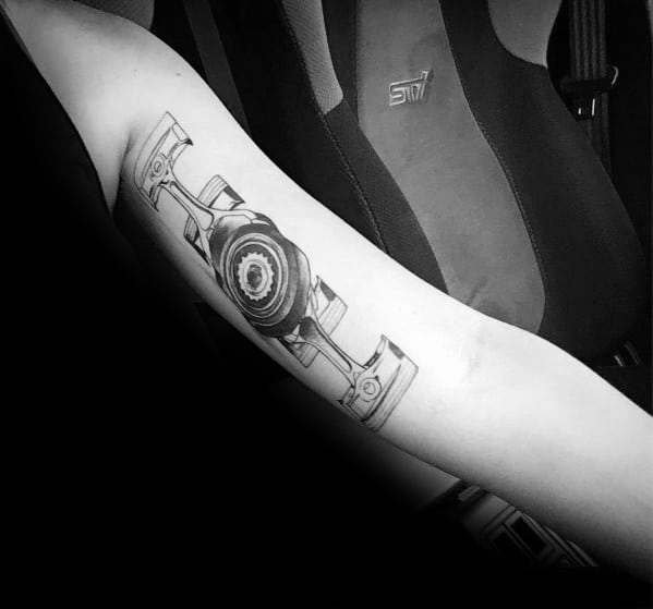 Realistic black and grey Subaru boxer engine tattoo on the forearm, featuring detailed pistons and gears, symbolizing performance and precision.