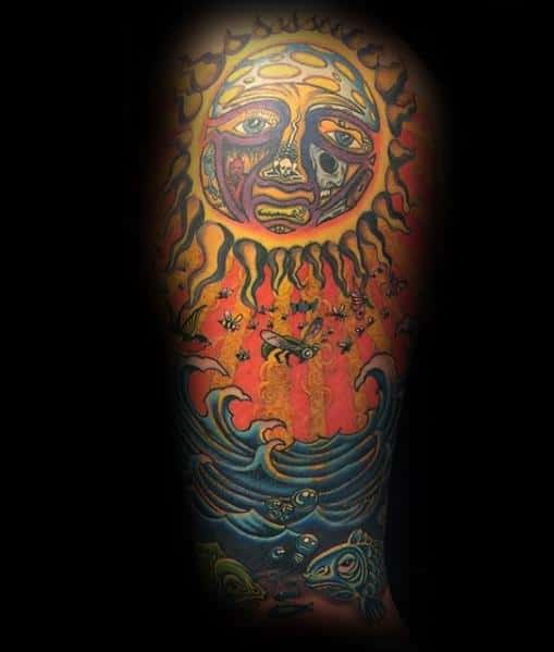 Full leg tattoo featuring the Sublime sun face shining down over fiery rays, bees, ocean waves, and detailed koi fish below.