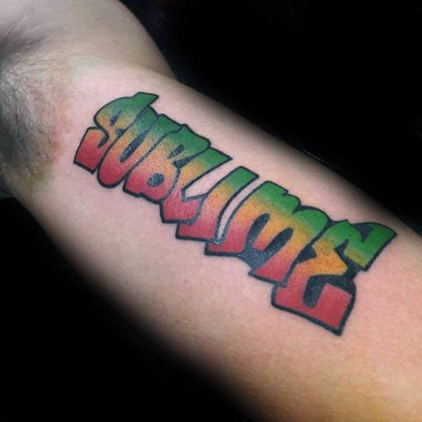 Forearm tattoo of the word “Sublime” in bold graffiti-style lettering with a red, yellow, and green gradient fill and black outline.