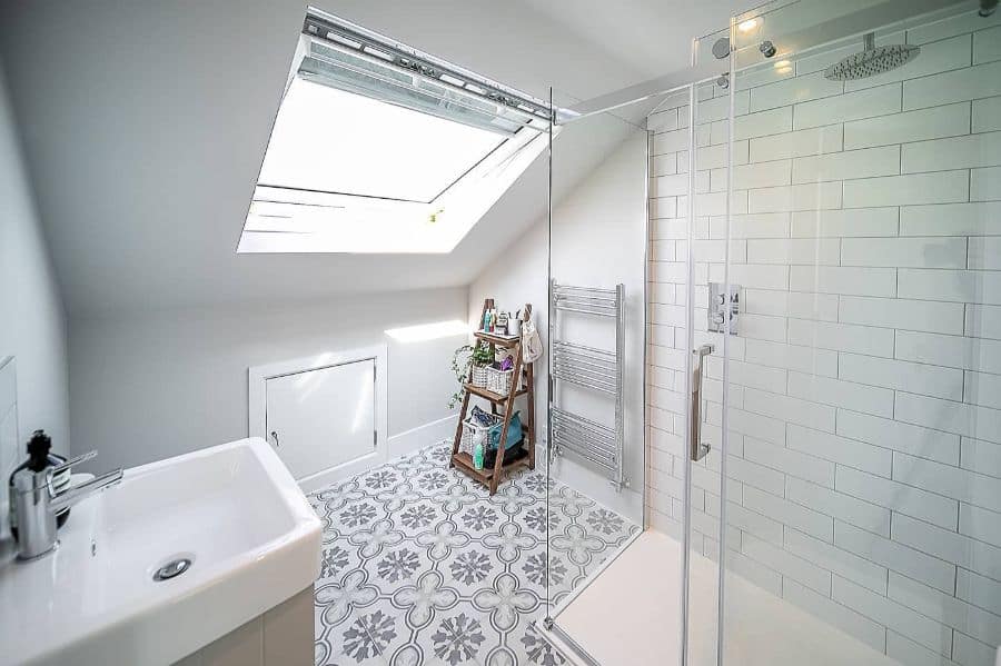 attic shower with white tiles and skylight