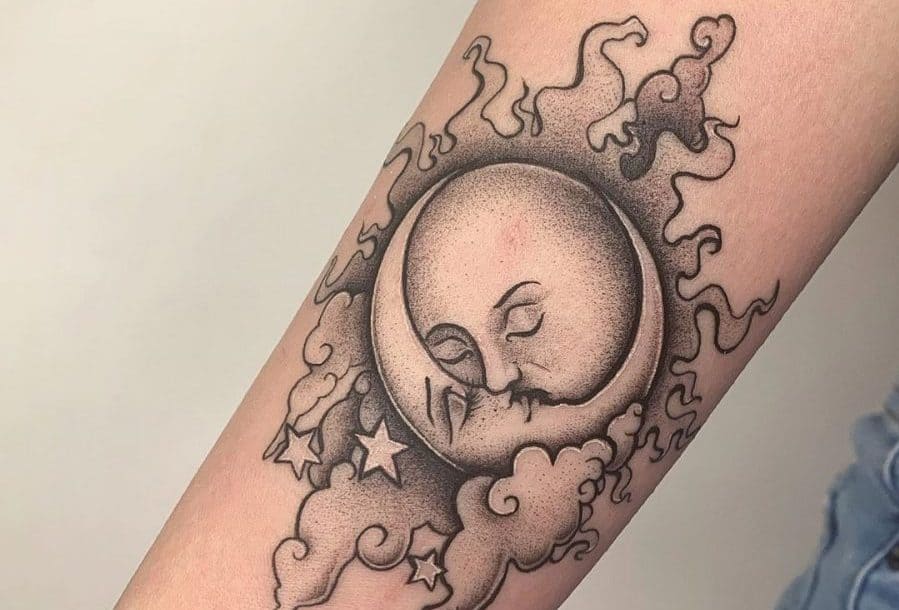 Black and grey tattoo of a sun and moon with serene faces, surrounded by swirling clouds and stars, featuring soft dotwork shading.