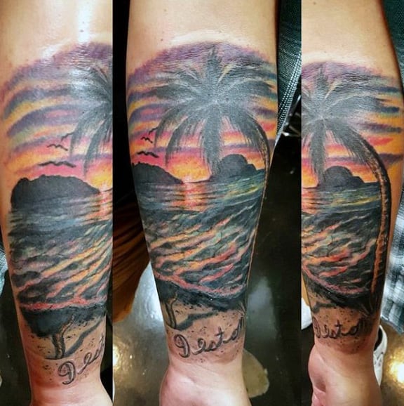 Sunset Tattoo On Mans Arm With Dramatic Color And Palm Tree