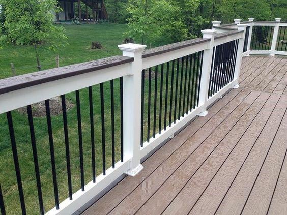 wood deck with white painted posts and black balusters