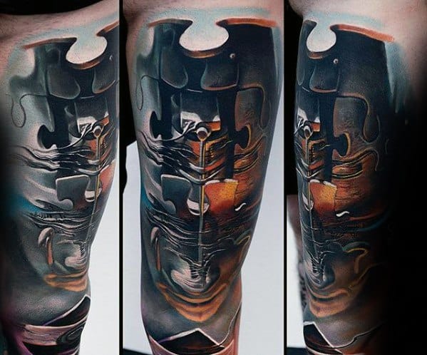 Surreal tattoo of a distorted violin melting into puzzle pieces, blending realism with abstract shapes in warm, moody tones.