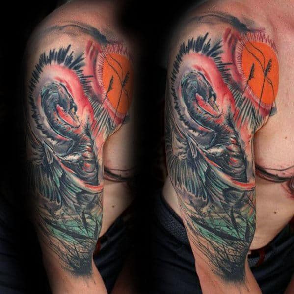 Dramatic swan tattoo sleeve with intense black feathers, vivid red sun, and green water elements, blending realism with abstract energy.