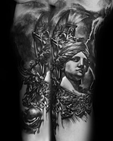 Athena tattoo in black and grey realism with layered helmets, detailed scale armor, and a calm expression against a stormy background
