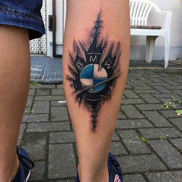 Bold BMW logo tattoo on calf, featuring a ripped skin effect with detailed shading for a striking and dynamic automotive design.
