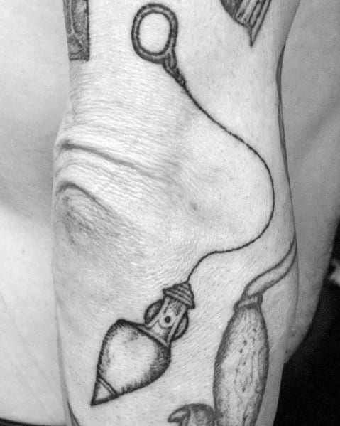 Black and gray tattoo of a plumb bob, symbolizing precision, balance, and the craftsmanship essential in carpentry and construction work.