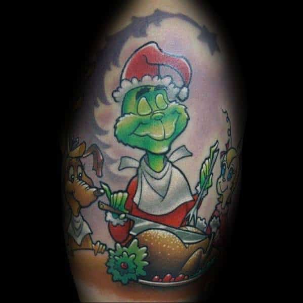 Christmas tattoo of the Grinch in a Santa hat, happily preparing a holiday feast with Max and Cindy Lou Who, capturing the heartwarming ending of *How the Grinch Stole Christmas*.