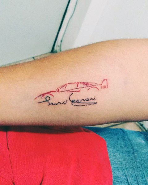 Minimalist Ferrari car outline tattoo with Enzo Ferrari's signature, symbolizing subtle elegance and automotive admiration on man's arm.