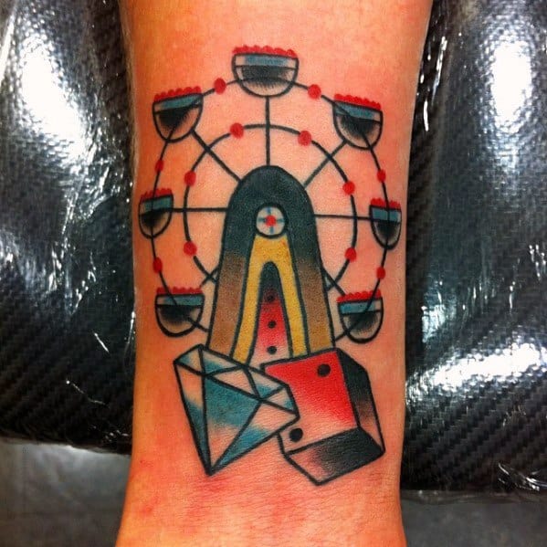 Bold Ferris wheel tattoo with a traditional style, featuring a diamond and dice, using vibrant red, blue, and yellow tones for a classic and playful look.