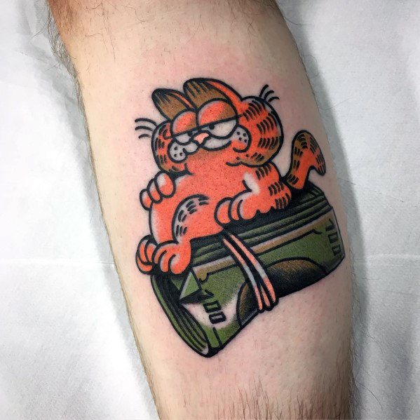 Garfield tattoo lounging on a roll of cash with a smug grin—bold, fun design perfect for a playful money-loving vibe.