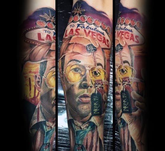 Colorful Hunter S. Thompson tattoo featuring a detailed portrait with aviator glasses, the "Welcome to Las Vegas" sign, and a "Drink Me" bottle in a surreal design.