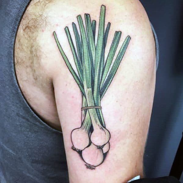 Colorful tattoo of a tied bundle of green onions on the upper arm, featuring fine line details, vibrant shading, and a natural botanical design.