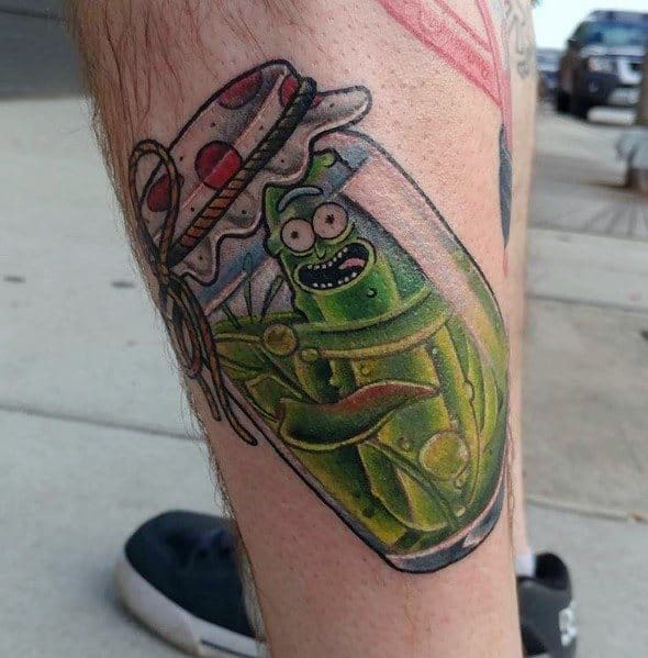 Pickle Rick tattoo in a detailed glass jar with vibrant green shading, featuring a fun and creative design on the leg.