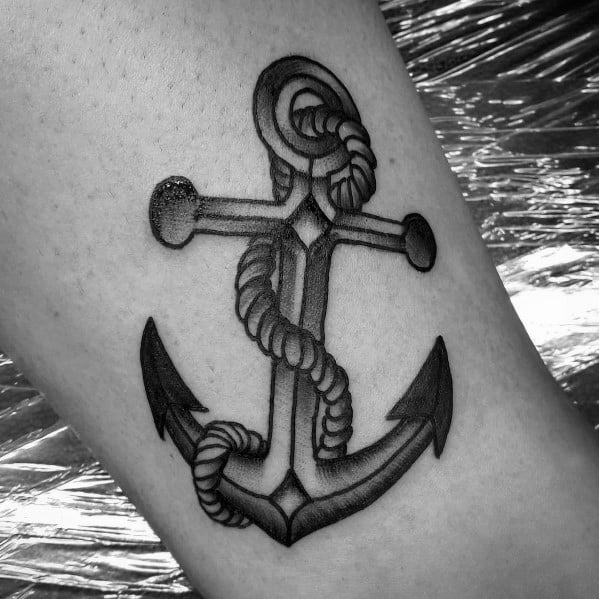 Realistic black and gray anchor tattoo with a detailed wrapped rope and shading, symbolizing strength, stability, and a deep nautical connection.
